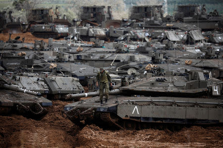 An Israeli soldier stands atop a tank near the border with Gaza, in southern Israel March 27, 2019. REUTERS/Amir Cohen