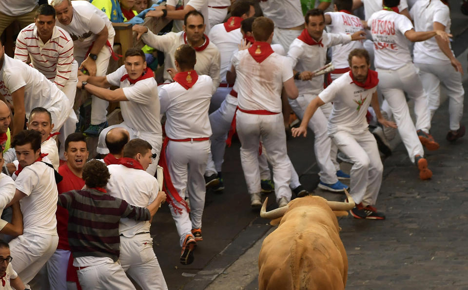 <p>Revellers run in front of Cebada Gago fighting bulls during the first running of the bulls at the San Fermin Festival, in Pamplona, northern Spain, July 7, 2017. (Alvaro Barrientos/AP) </p>