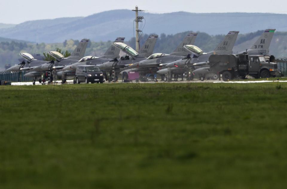 US F16 fighter jets are parked on a runway at a Romanian air base in Campia Turzii, Romania, Thursday, April 10, 2014. Some 450 U.S. and Romanian troops are taking part in the Dacian Viper 2014 joint military exercise in Transylvania, northwestern Romania flying U.S. F-16 fighter jets of the U.S. 31st Fighter Wing alongside Romanian Mig-21 Lancers.The weeklong exercise, the fourth of its kind, was planned before Russia’s recent annexation of Crimea, according to officials.(AP Photo/Vadim Ghirda)