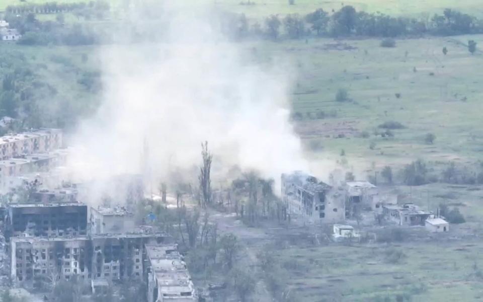 Smoke from artillery strikes rises over damaged buildings amid military presence in Toshkivka, Luhansk region, Ukraine in this screengrab taken from a drone video released on June 19, 2022 - Video obtained by Reuters