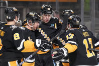 Pittsburgh Penguins' Evgeni Malkin (71) celebrates his first of two goals against the Columbus Blue Jackets with Sidney Crosby, second from left, Michael Bunting (8), Kris Letang (58), and Bryan Rust (17) during the second period of an NHL hockey game in Pittsburgh, Thursday, March 28, 2024. (AP Photo/Gene J. Puskar)