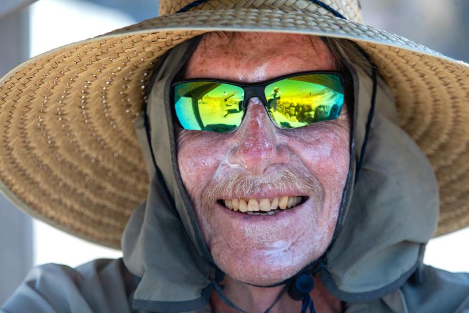 <p>Francine Orr/Los Angeles Times/Getty </p>  Steve Curry, 71, of Sunland, smiles as he sits in the shade after walking to Zabriskie Point in Death Valley National Park on Tuesday, July 18, 2023, in Death Valley, CA