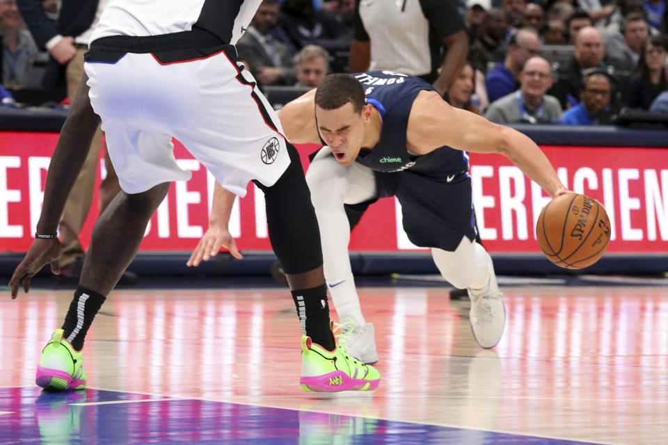 Dallas center Dwight Powell went down with an Achilles injury in the first quarter against the Clippers on Tuesday night, and is expected to miss the rest of the season. (AP/Richard W. Rodriguez)