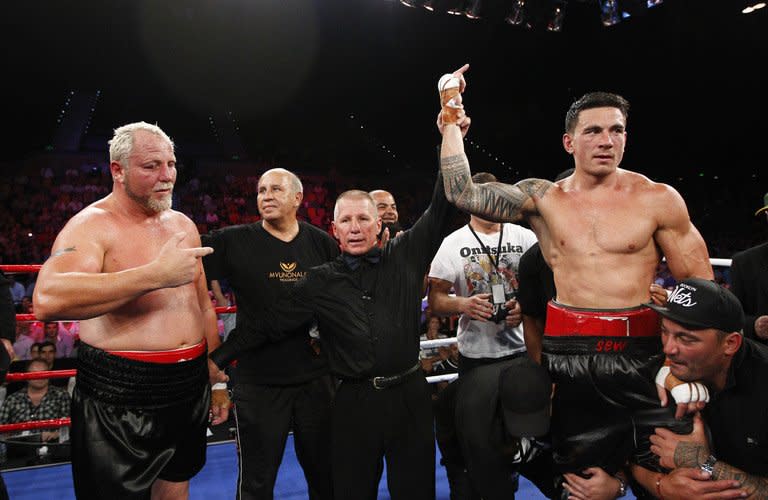 World Cup-winning ex-All Black Sonny Bill Williams (R) celebrates victory over Francois Botha of South Africa after their WBA International Heavyweight Title fight at the Brisbane Entertainment Centre in Australia, on February 8, 2013