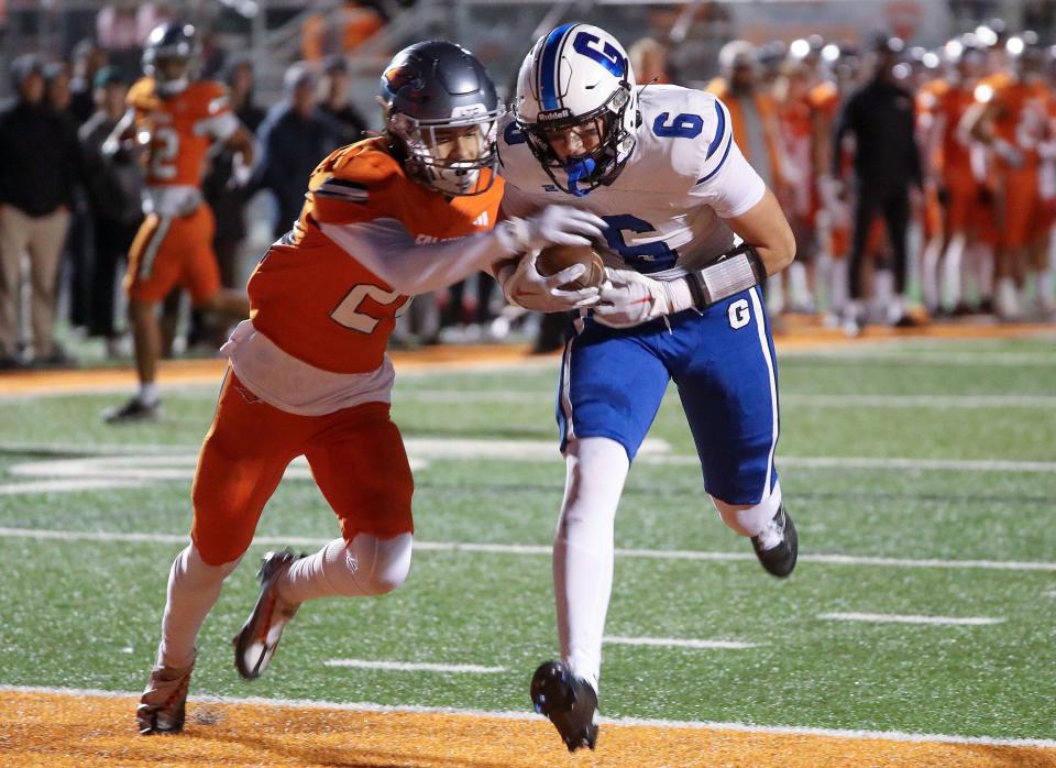 Pleasant Grove’s Makai Peterson (6) completes a pass and scores a touchdown as Skyridge’s Mark Baird tries to get the ball during a 6A quarterfinal football game at Skyridge High School in Lehi on Friday, Nov. 3, 2023. Skyridge won 37-30 in overtime. | Kristin Murphy, Deseret News