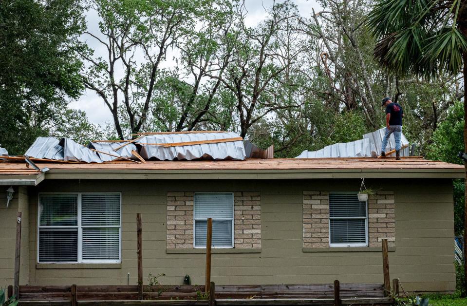 Justin Wilson takes his first look at the damage done to a house on Puckett Street in Perry, Fla., following Hurricane Idalia's landfall in Keaton Beach Wednesday morning, Aug. 30, 2023.