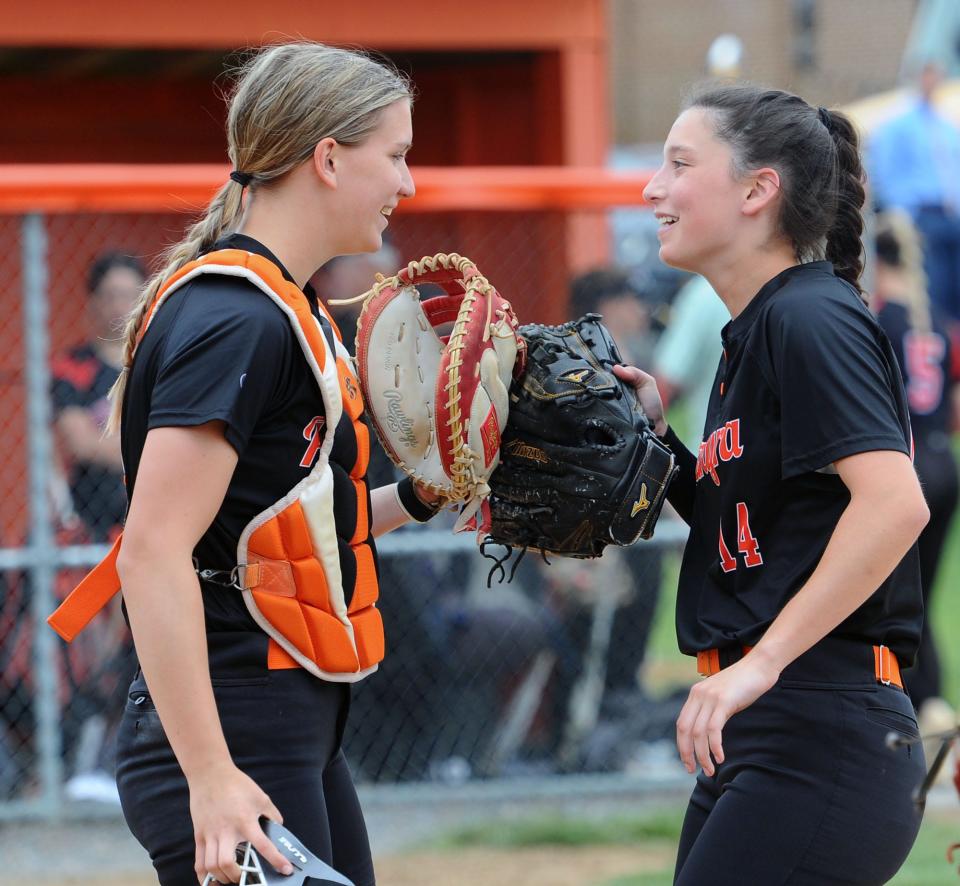 Palmyra pitcher Mollie White, right, talks to her catcher, Samantha Krahling, during a game in the 2022 season.