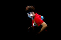 LONDON, ENGLAND - AUGUST 07: Tianwei Feng of Singapore competes against Kyung Ah Kim of Korea during the Women's Team Table Tennis bronze medal match on Day 11 of the London 2012 Olympic Games at ExCeL on August 7, 2012 in London, England. (Photo by Feng Li/Getty Images)