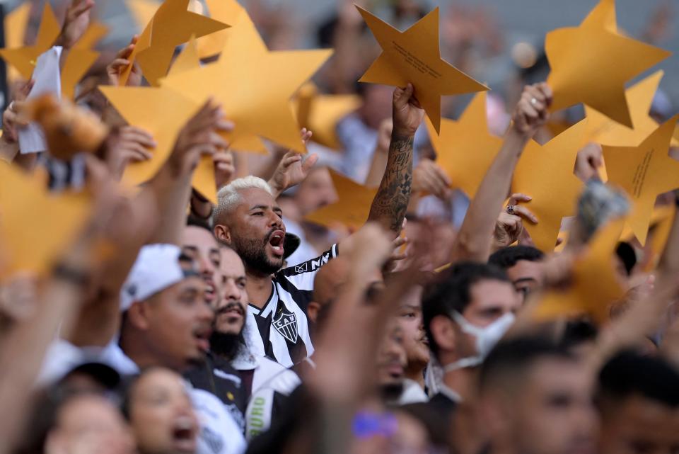 Fans of Atletico Mineiro celebrate winning the Brazilian 2021 football championship before the match against Red Bull Bragantino, at the Mineirao stadium in Belo Horizonte, on December 5, 2021. - After 50 years the Atl&#xe9;tico Mineiro won the Brazilian championship last December 2nd, after defeating Bahia at Fonte Nova stadium, in Salvador, Brazil. (Photo by DOUGLAS MAGNO / AFP) (Photo by DOUGLAS MAGNO/AFP via Getty Images)