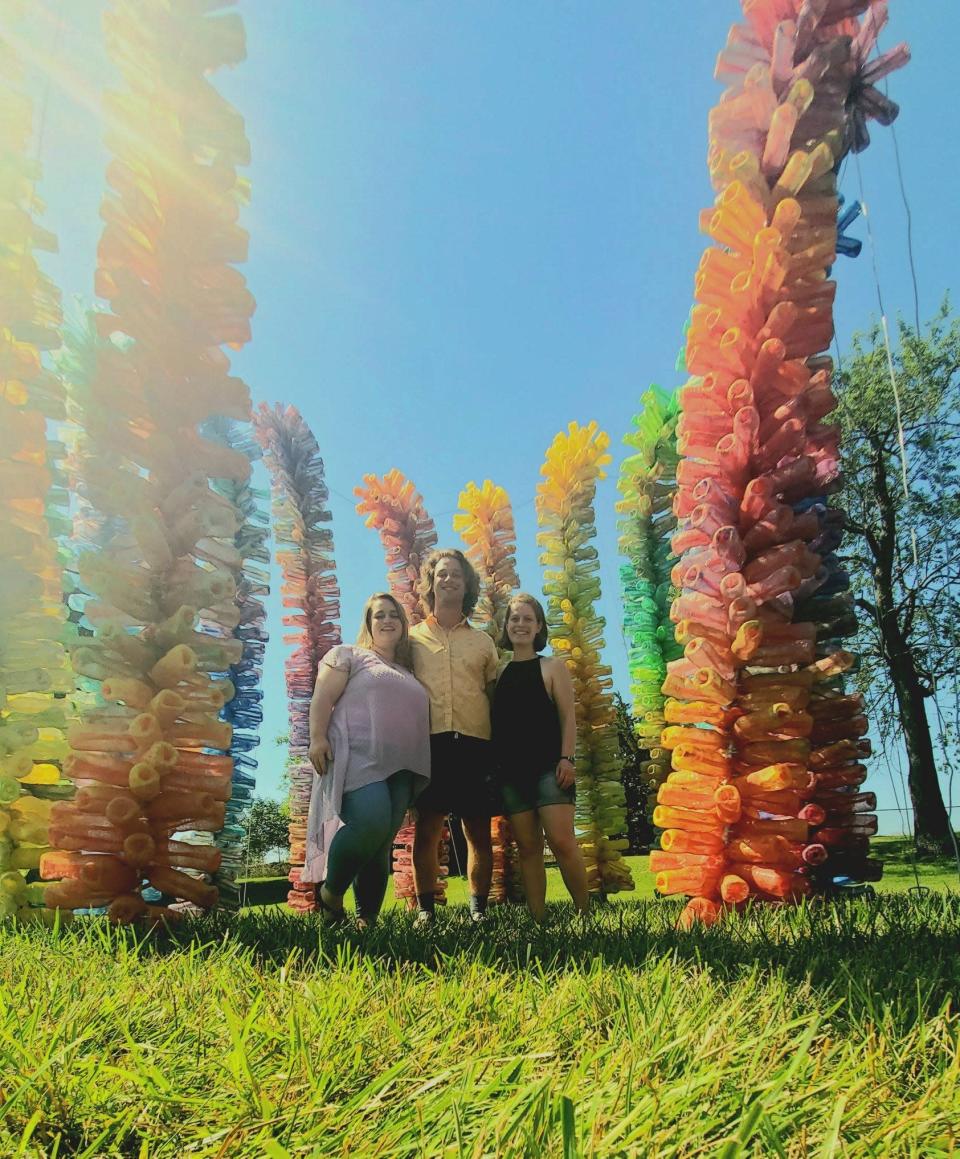 Siblings Alyssa, Justin and Emily Lytle pose at a public art display in Lewes.