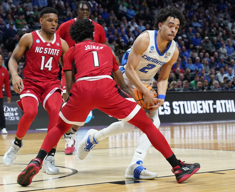 Creighton guard Ryan Nembhard, right, drives the lane as North Carolina State guard Jarkel Joiner defends in the first half of a first-round college basketball game in the men's NCAA Tournament Friday, March 17, 2023, in Denver. (AP Photo/John Leyba)