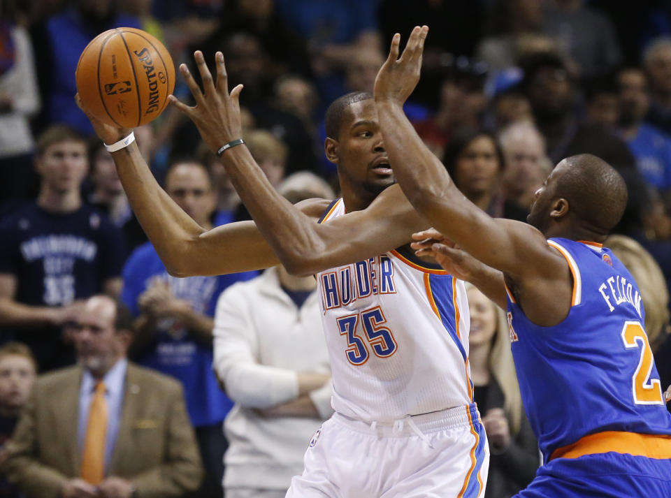 Oklahoma City Thunder forward Kevin Durant (35) is pressured by New York Knicks guard Raymond Felton (2) in the first quarter of an NBA basketball game in Oklahoma City, Sunday, Feb. 9, 2014. (AP Photo/Sue Ogrocki)