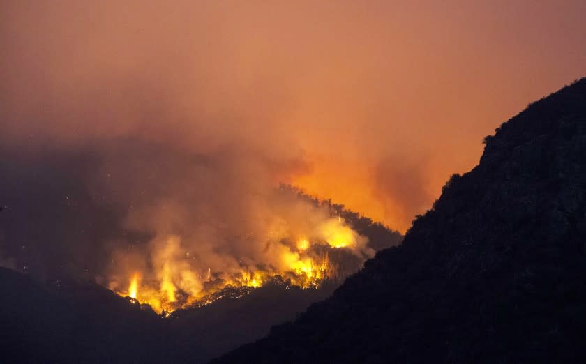 September 15, 2021: Flames burn through brush on a hillside near the entrance station to Sequoia National Park