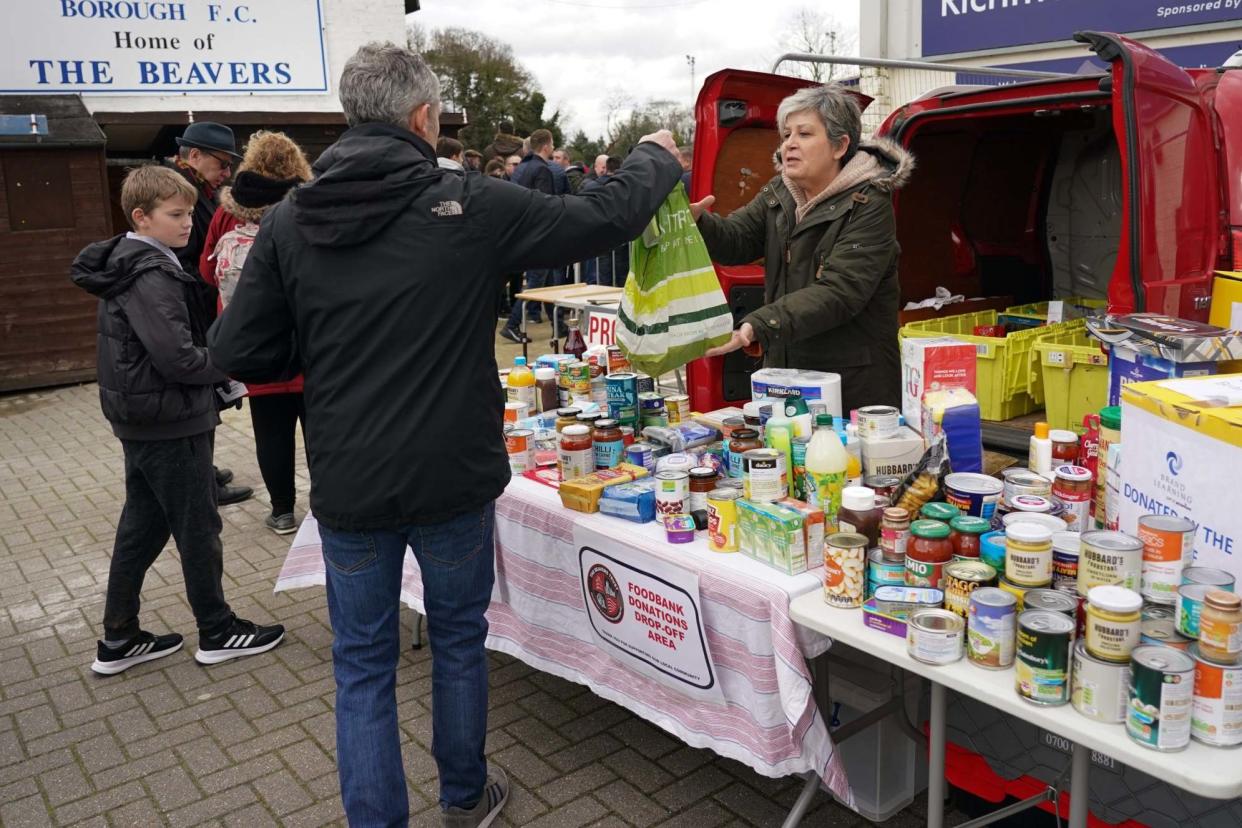 Football fans donate to a food bank in London: BPI/Rex