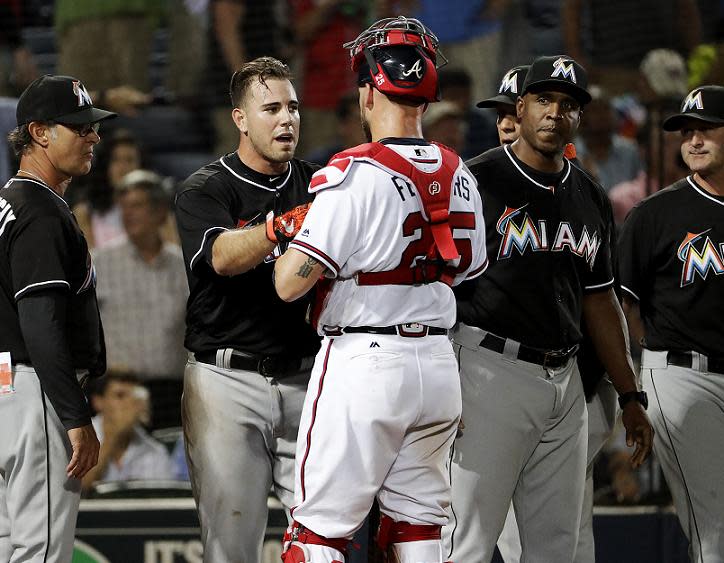 Jose Fernandez talks with Braves catcher Tyler Flowers after reliever Jose Ramirez threw a pitch near his head. (AP)