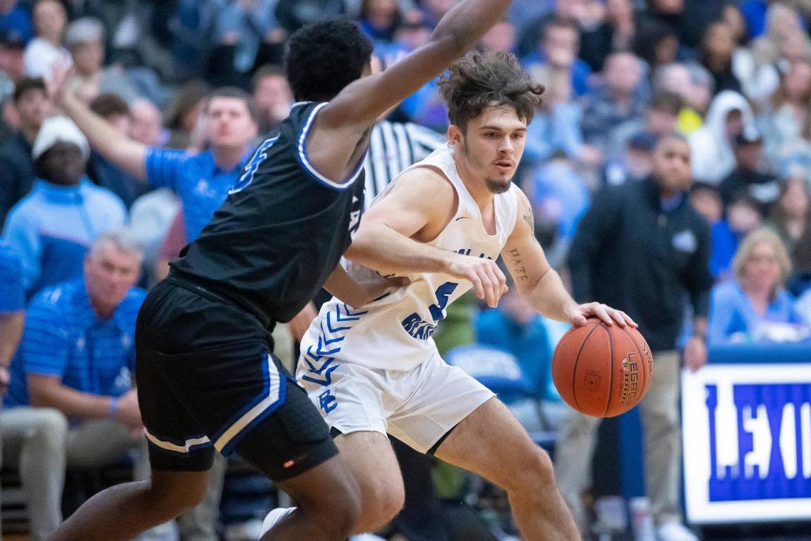 Bracken County’s Blake Reed (5) tries to drive around Mason County’s Khristian Walton (5) during Tuesday’s game at Lexington Catholic. Reed surpassed 3,000 career points during the loss.