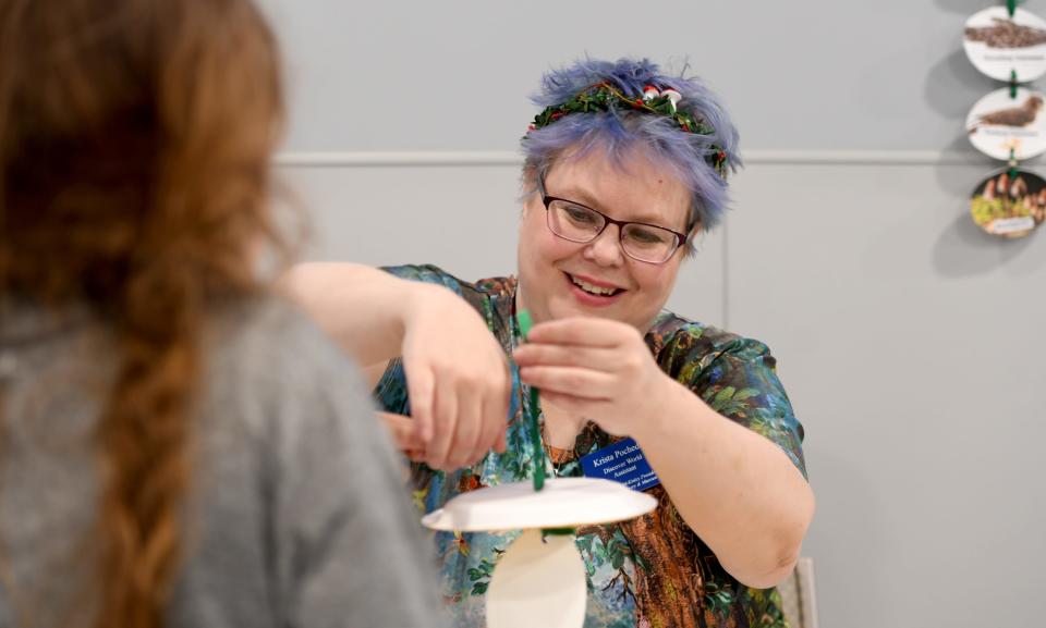 Krista Pochedly, a Discover World assistant, helps create a food chain during the recent Wm. McKinley Presidential Library & Museum Science Earth Day celebration.