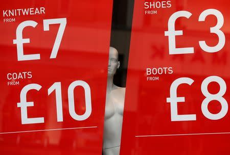 A mannequin stands in the window of a clothes shop in Leicester, central England, January 8, 2013. REUTERS/Darren Staples