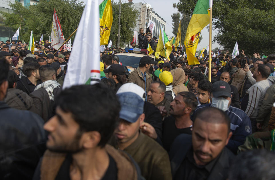 Mourners march during the funeral of Iran's top general Qassem Soleimani, 62, Abu Mahdi al-Muhandis, deputy commander of Iran-backed militias in Iraq known as the Popular Mobilization Forces and fellow militant leaders, in Baghdad, Iraq, Saturday, Jan. 4, 2020. Thousands of mourners chanting "America is the Great Satan" marched in a funeral procession Saturday through Baghdad for Iran's top general and Iraqi militant leaders, who were killed in a U.S. airstrike. (AP Photo/Nasser Nasser)