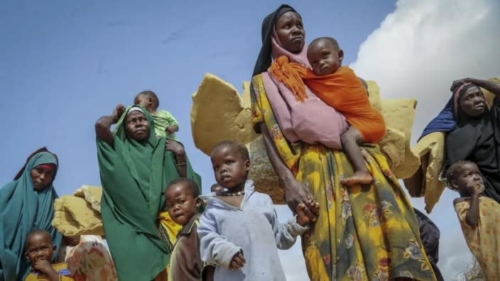 Somalis who fled drought-stricken areas carry their belongings as they arrive at a makeshift camp for the displaced on the outskirts of Mogadishu, Somalia in June. Elections, coups, disease outbreaks and extreme weather are some of the main events that occurred across Africa in 2022. (Photo: Farah Abdi Warsameh/AP)