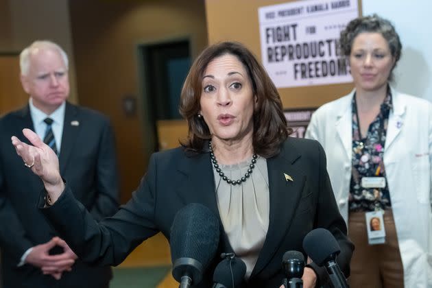 Minnesota Gov. Tim Walz, left, and Dr. Sarah Traxler, the chief medical officer at Planned Parenthood North Central States, stand behind U.S. Vice President Kamala Harris after a tour at Planned Parenthood on March 14, 2024, in St. Paul.