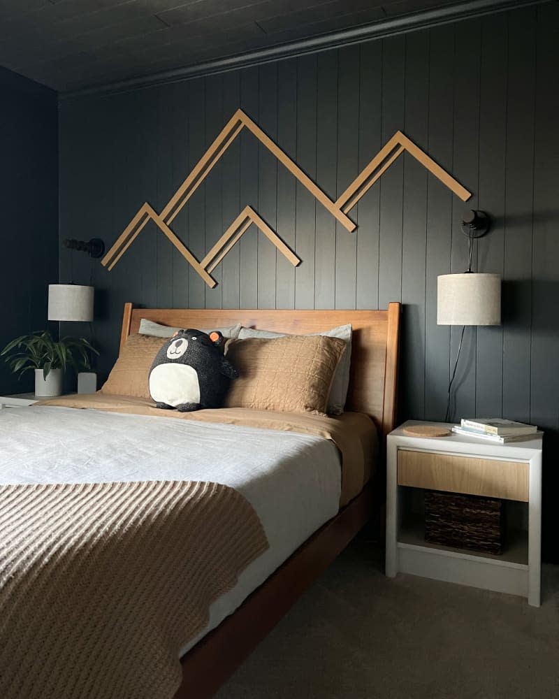 Mountain frames on black painted walls in child's room.