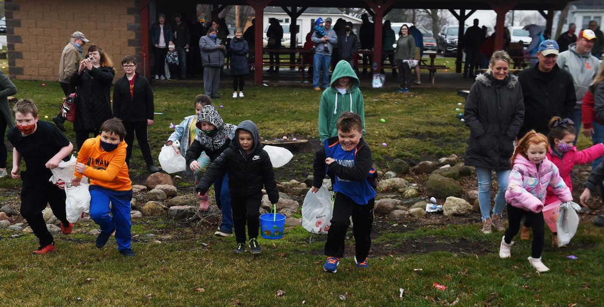 Children rush to look for Easter eggs during the  McCallsburg Lions' annual Easter egg hunt at the city park Saturday, March 27, 2021, in MaCallsburg, Iowa.