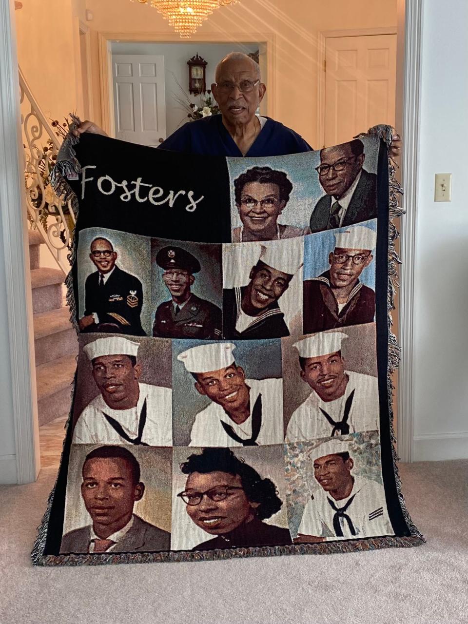 Donald Foster holds a blanket featuring his parents, Robert and Louise Foster, and his nine siblings in his home in Chillicothe on July 11, 2023.
