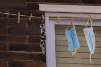 Single use face masks used to prevent the spread of the coronavirus are left to dry on a balcony in the southern neighbourhood of Vallecas in Madrid, Spain, Monday, Sept. 21, 2020. In Spain, nearly 36,000 have died and more than 1.2 million have contracted the virus, although the real infection tally could be at least three times higher. (AP Photo/Bernat Armangue)