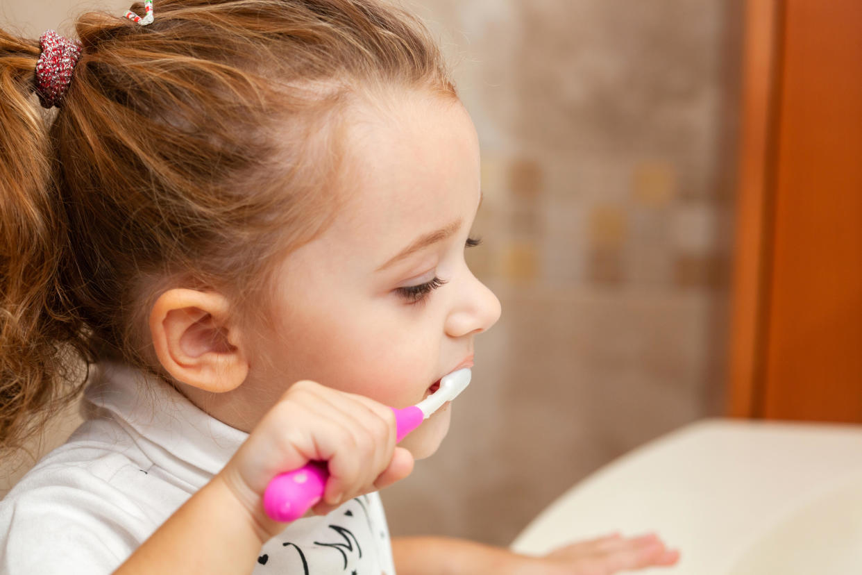 Portrait of little girl cleaning her teeth (Alamy/PA)