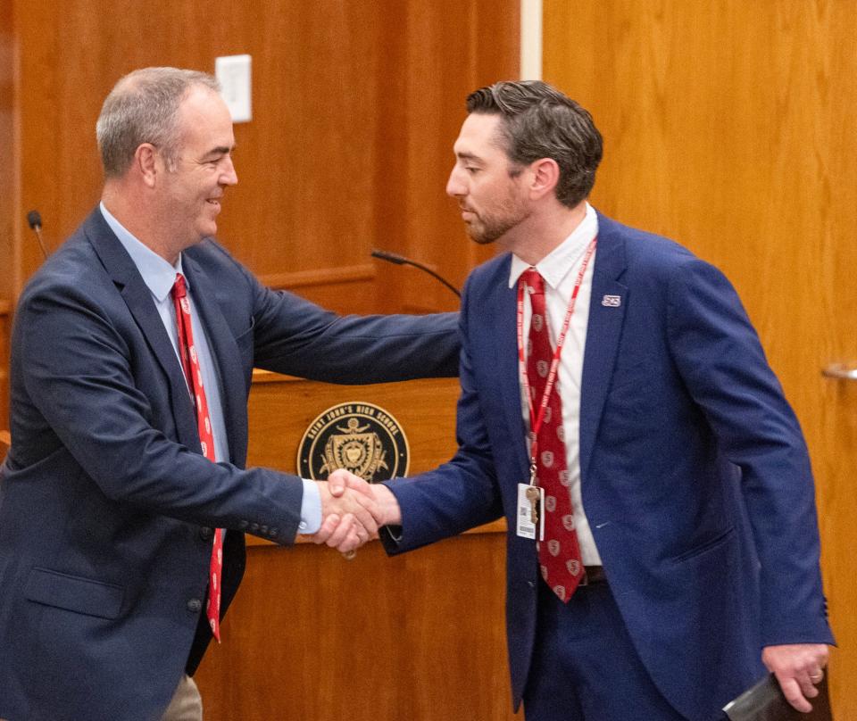 St. John's athletic director Michael Mead welcomes new baseball coach Casey Cummins on Wednesday.