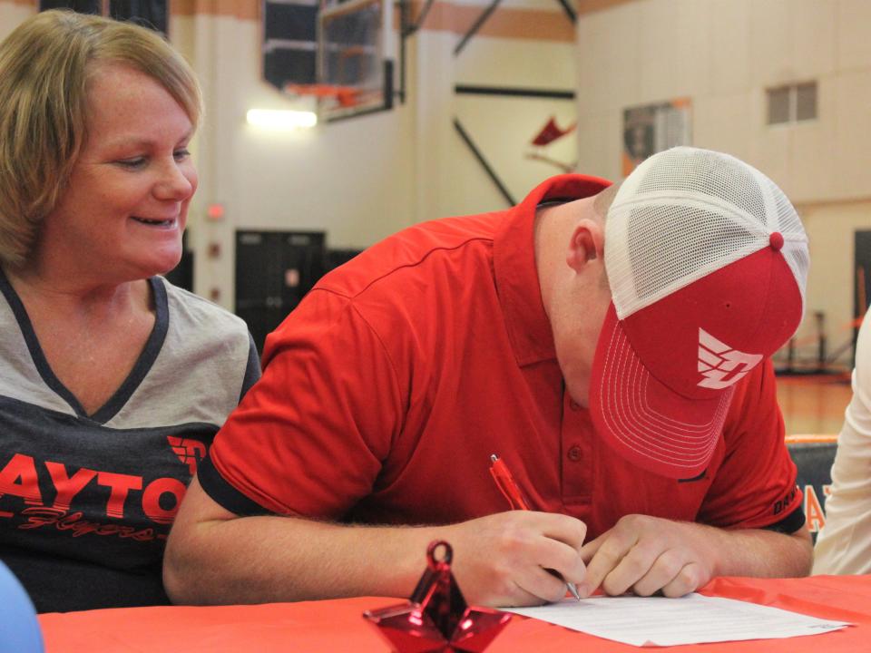 Taunton baseball's Ryan MacDougall signs his National Letter of Intent to play for the University of Dayton as mom Lisa MacDougall watches on during a signing ceremony on Nov. 14, 2022.