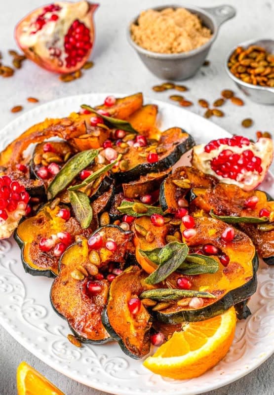 <p>Flavor Mosaic</p><p>These sweet and spicy sliced squash pieces are oven-roasted with pumpkin seeds and pomegranate seeds to make an impressive and festive Thanksgiving side dish for your holiday dinner.</p><p><strong>Get the recipe: <a href="https://flavormosaic.com/baked-acorn-squash-slices/" rel="nofollow noopener" target="_blank" data-ylk="slk:Baked Acorn Squash Slices;elm:context_link;itc:0;sec:content-canvas" class="link ">Baked Acorn Squash Slices</a></strong></p>