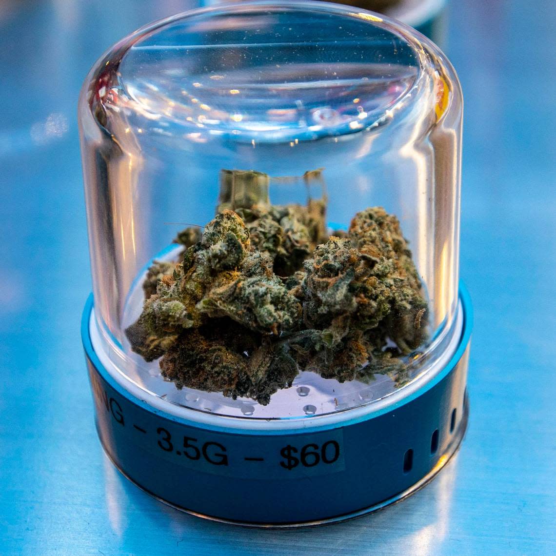 An eighth of ‘Dying Dreaming’ indoor marijuana strain priced at $60 dollars sits inside a display pod during the grand opening of Cookies Miami, Florida’s first and only minority-owned marijuana dispensary, in Miami, Florida, on Saturday, August 13, 2022.