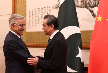 Pakistan’s Foreign Minister Khawaja Muhammad Asif (left) shakes hands with Chinese State Councilor and Foreign Minister Wang Yi (right) at the Diaoyutai State Guest House in Beijing, China, April 23, 2018. Madoka Ikegami/Pool via Reuters