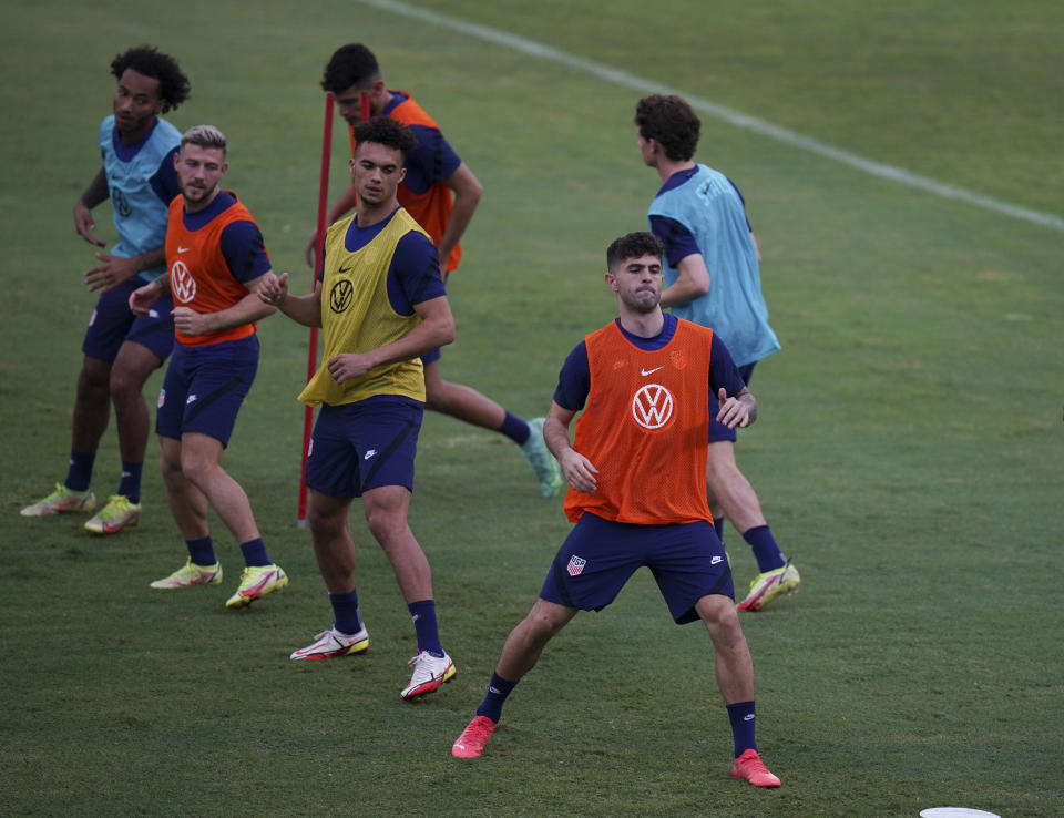 United States' Christian Pulisic, front, leads the warm up session during a training session ahead of the World Cup 2022 qualifying soccer match against Jamaica in Kingston, Monday, Nov. 15, 2021.(AP Photo/Fernando Llano)