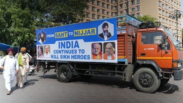 A truck parked near the Golden Temple in Amritsar, Punjab, on Thursday includes a photo on its side of Hardeep Singh Nijjar, a prominent Sikh Canadian activist who was shot multiple times and died outside the Guru Nanak Sikh Gurdwara in Surrey, B.C., on June 18, 2023.