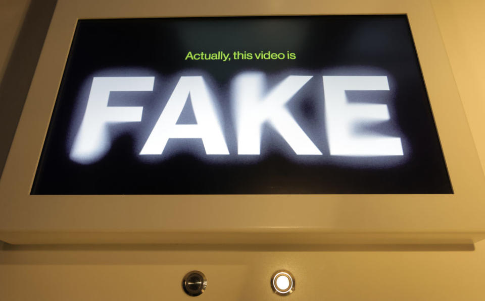Monitor displaying the message "Actually, this video is FAKE" to indicate counterfeit content