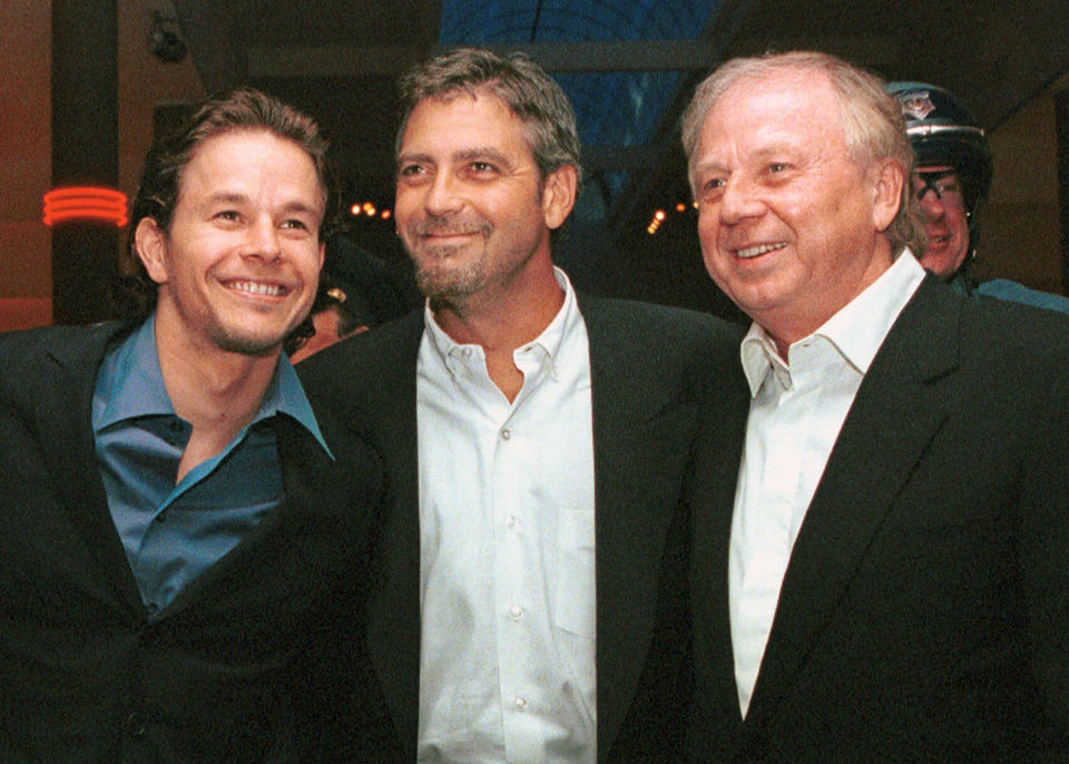 FILE - Actors Mark Wahlberg, left, and George Clooney, center, stars of the film "The Perfect Storm,'' pose with director/producer Wolfgang Petersen at the premiere in Danvers, Mass., on June 28, 2000. Petersen, the German filmmaker whose WWII submarine epic “Das Boot” propelled him into a blockbuster Hollywood career, died Friday at his home in the Los Angeles neighborhood of Brentwood after a battle with pancreatic cancer. He was 81. (AP Photo/Lisa Poole, File)