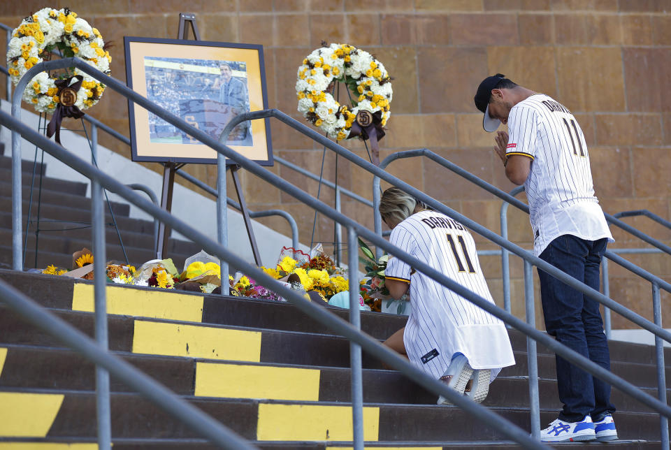 San Diego Padres pitcher Yu Darvish, right, pays his respects at a public memorial on the steps of Petco Park for Padres owner Peter Seidler, Tuesday, Nov. 14, 2023 in San Diego, Calif. The San Diego Padres announced Tuesday that Seidler has died. (K.C. Alfred/The San Diego Union-Tribune via AP)