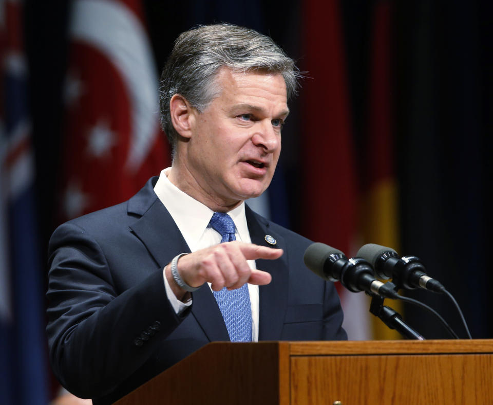 FILE - In this June 7, 2019, file photo, Director of the Federal Bureau of Investigation, Christopher Wray, gestures as he speaks during a graduation ceremony for students of the Federal Bureau of Investigations National Academy at the FBI training facility in Quantico, Va. Wray is set to testify before a Senate committee in what could be a preview of the questioning special counsel Robert Mueller may face on Wednesday, July 24, 2019. (AP Photo/Steve Helber, File)