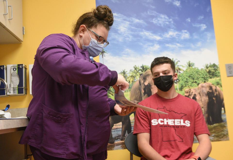 Andrew Huxley, 15, hears about the COVID-19 vaccine from LPN Jaclyn Niska Tuesday, May 18, 2021, at CentraCare Plaza Pediatrics. 