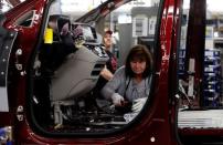 An FCA assembly worker works on the production line of the all-new 2017 Chrysler Pacifica minivan at the FCA Windsor Assembly plant in Windsor, Ontario, May 6, 2016. REUTERS/Rebecca Cook