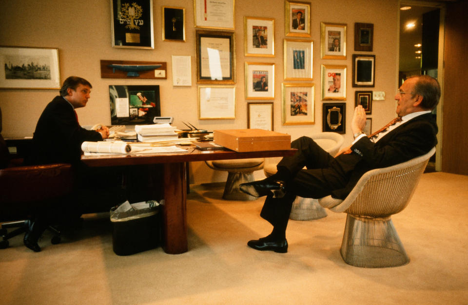 Donald Trump meets with Chrysler CEO Lee Iacocca at Trump's office in New York in 1987.