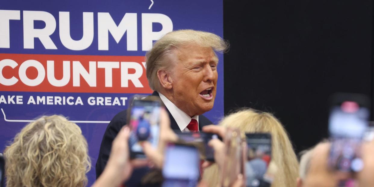 Donald Trump in front of a group of people holding phones at a campaign event in Grimes, Iowa, in June 2023.