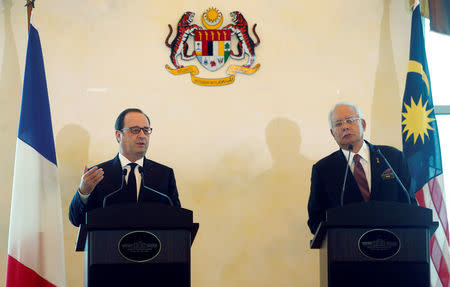 French President Francois Hollande (L) speaks as Malaysia's Prime Minister Najib Razak listens during a joint news conference in Putrajaya, Malaysia March 28, 2017. REUTERS/Lai Seng Sin