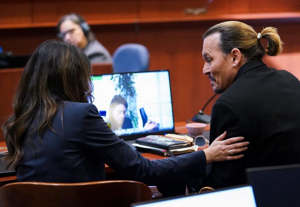 Johnny Depp and Camille Vasquez together at the Fairfax County Courthouse on 18 May (KEVIN LAMARQUE/POOL/AFP via Getty Images)