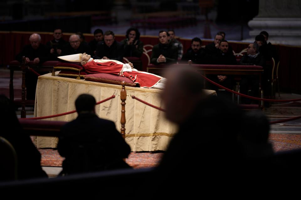 The body of Pope Emeritus Benedict XVI lies in state at St. Peter's Basilica on Monday in Rome. Benedict died early Saturday at a monastery in the Vatican.
