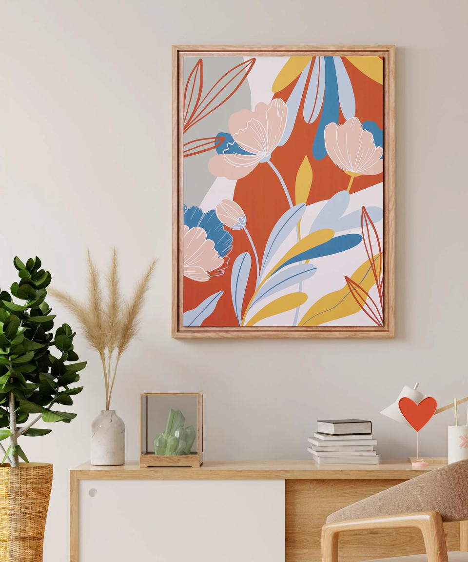 Colorful floral artwork in wooden frame, mounted on wall