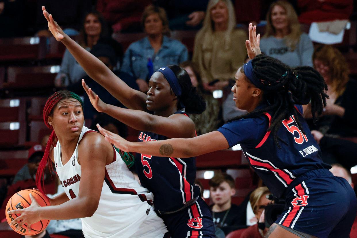 Aliyah Boston (left) looks to move past two defenders during South Carolina's game against Auburn.